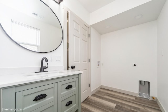 bathroom featuring vanity and hardwood / wood-style flooring