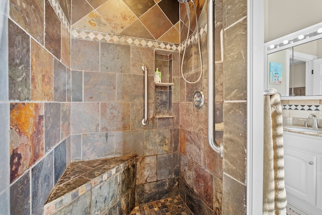 bathroom featuring vanity and a tile shower