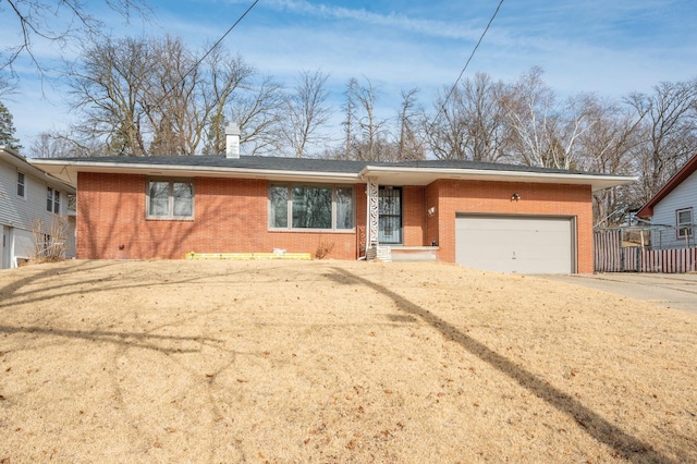 single story home featuring a garage and a front lawn