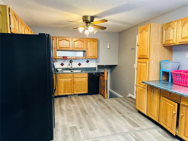 kitchen with light hardwood / wood-style flooring, black appliances, sink, backsplash, and a textured ceiling