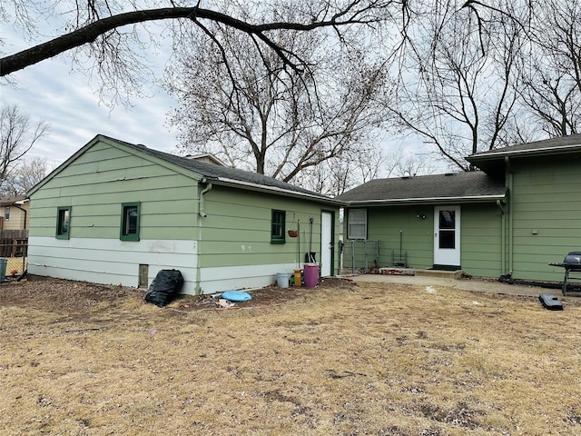 back of property featuring a lawn