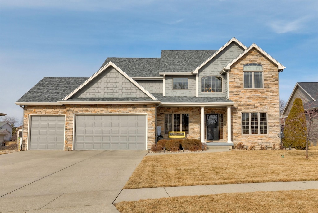 craftsman-style house featuring a garage and a front yard