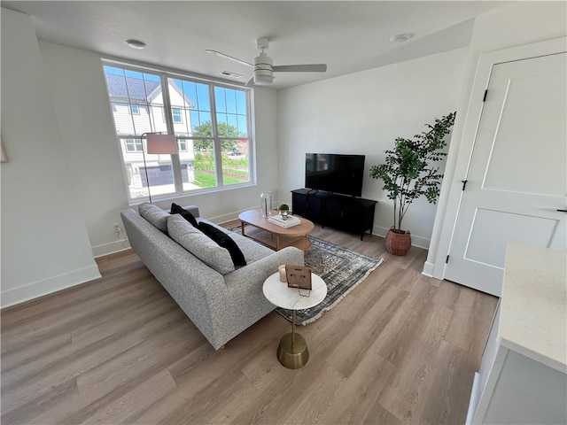 living room featuring ceiling fan and light wood-type flooring