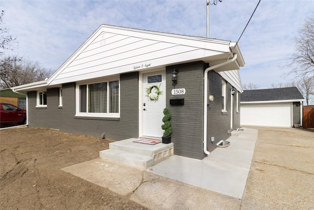 view of front of house with a garage and an outdoor structure