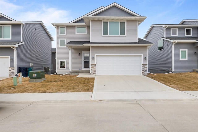 view of front of property featuring cooling unit, a garage, and a front lawn