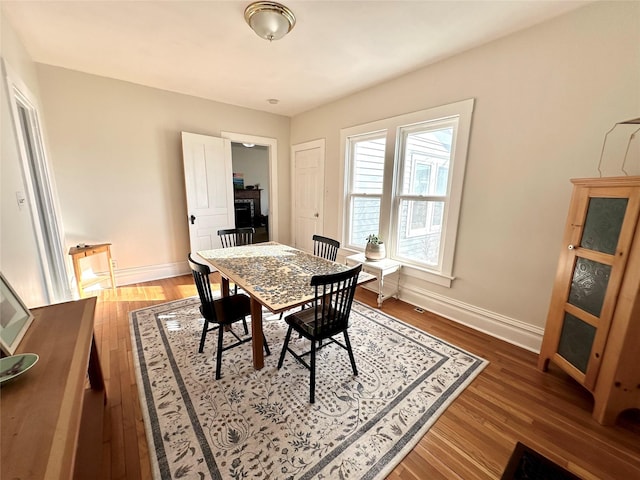 dining room with dark hardwood / wood-style flooring