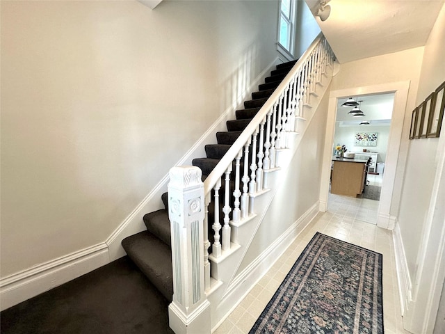 stairway with tile patterned flooring