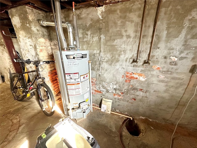 utility room featuring gas water heater