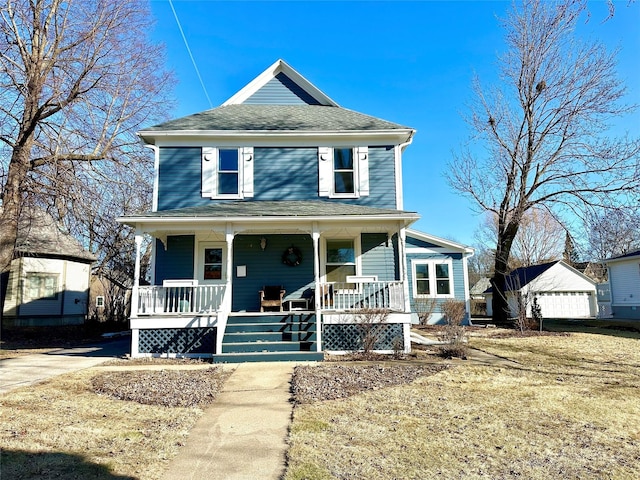 view of front of property featuring a garage, an outbuilding, and covered porch