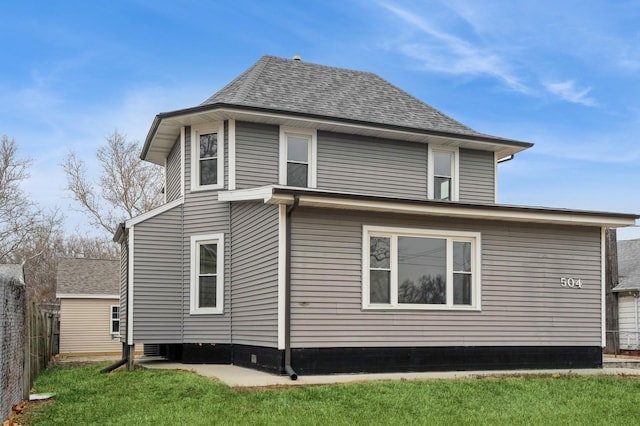 504 E Jackson Ave, Des Moines, IA 50315 - view of home's exterior with a shingled roof and fence