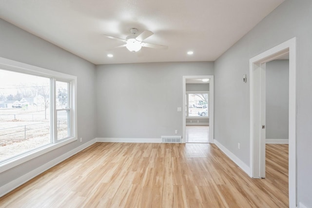 spare room with visible vents, baseboards, recessed lighting, light wood-style floors, and a ceiling fan