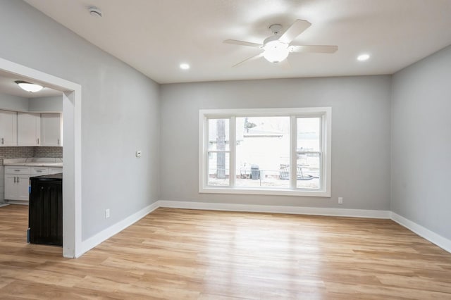 spare room with recessed lighting, baseboards, a ceiling fan, and light wood finished floors