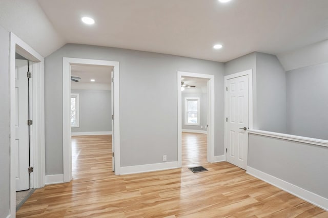 additional living space featuring lofted ceiling, recessed lighting, light wood-style floors, and baseboards