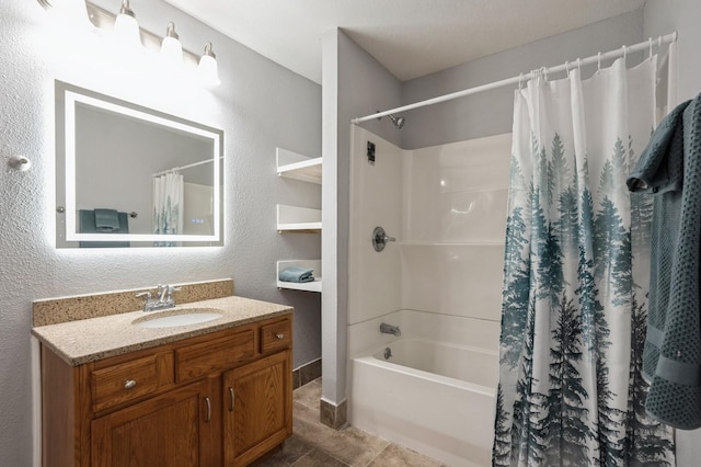 504 E Jackson Ave, Des Moines, IA 50315 - bathroom featuring vanity, shower / tub combo, and a textured wall