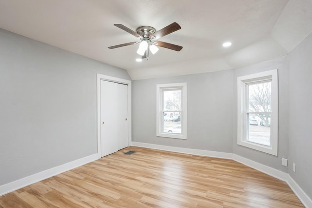 504 E Jackson Ave, Des Moines, IA 50315 - unfurnished bedroom featuring multiple windows, light wood-type flooring, lofted ceiling, ceiling fan, and recessed lighting