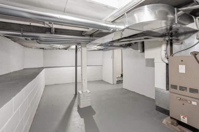 unfinished basement featuring heating unit