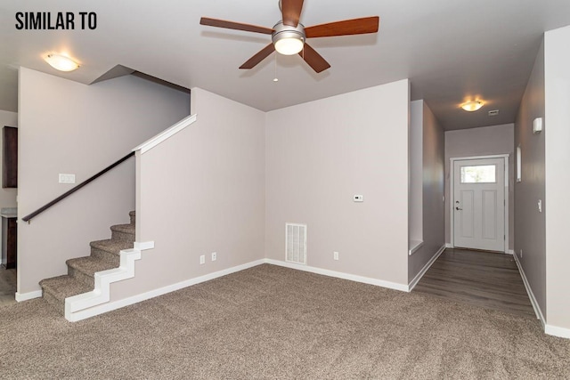 unfurnished living room featuring ceiling fan and carpet