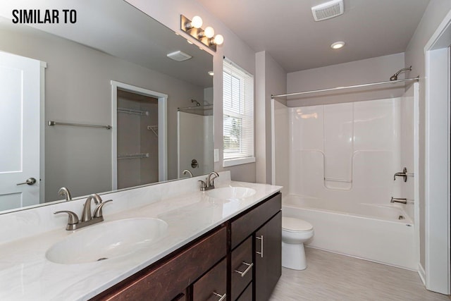 full bathroom with vanity, shower / bathing tub combination, toilet, and hardwood / wood-style flooring