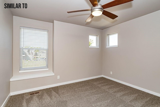 carpeted spare room featuring ceiling fan