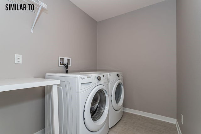 laundry room featuring light hardwood / wood-style flooring and washer and clothes dryer