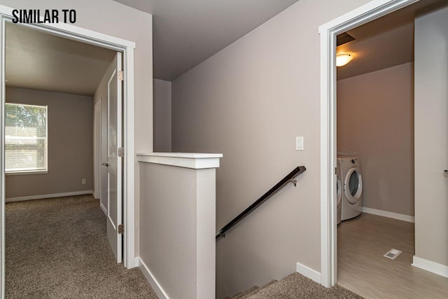 stairs featuring washer / clothes dryer and carpet floors