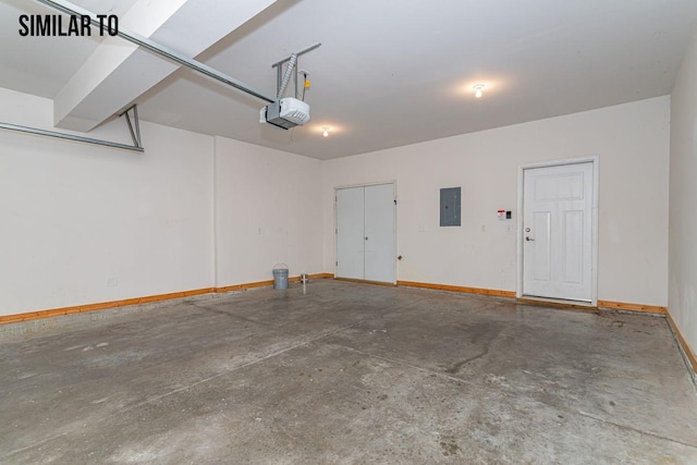 garage with a garage door opener and electric panel