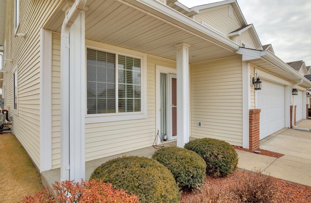 doorway to property with a garage and covered porch