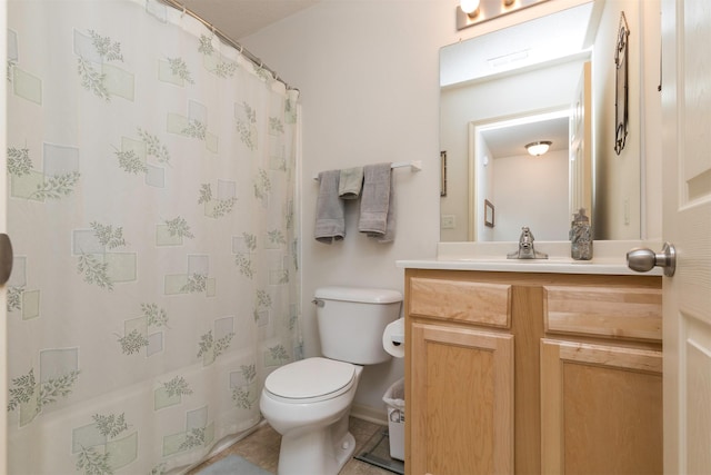 bathroom with vanity, curtained shower, and toilet