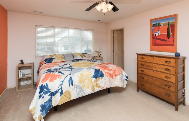 bedroom with ceiling fan and light colored carpet