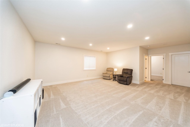 living area with light colored carpet