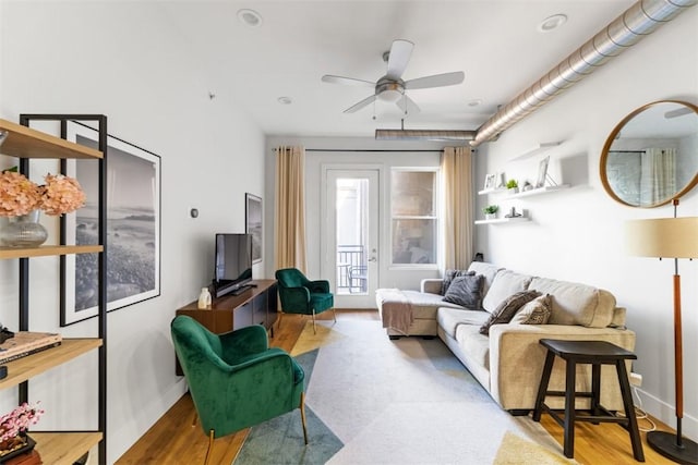 living room featuring hardwood / wood-style flooring and ceiling fan