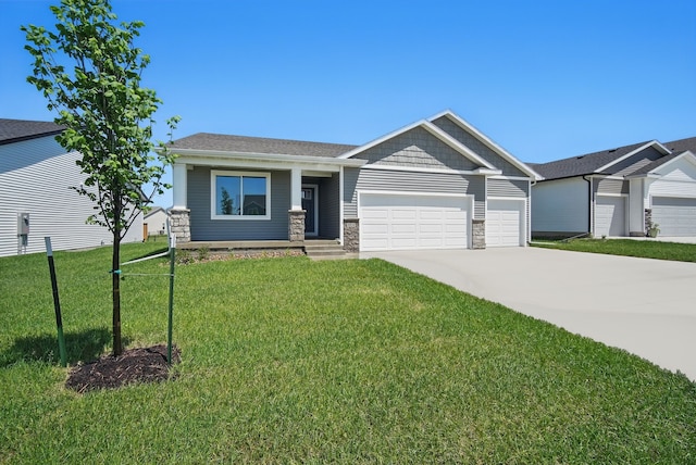 1939 Tuscany Dr SE, Altoona, IA 50009 - craftsman house featuring stone siding, driveway, a garage, and a front lawn