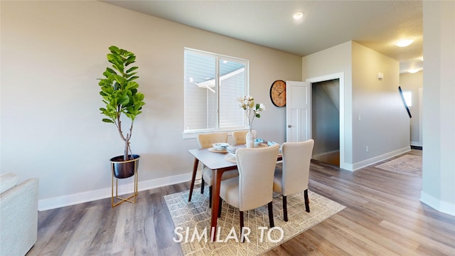 dining room featuring wood finished floors and baseboards