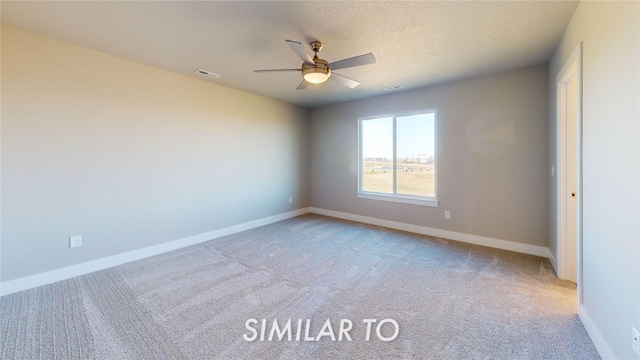 carpeted empty room featuring visible vents, baseboards, and ceiling fan