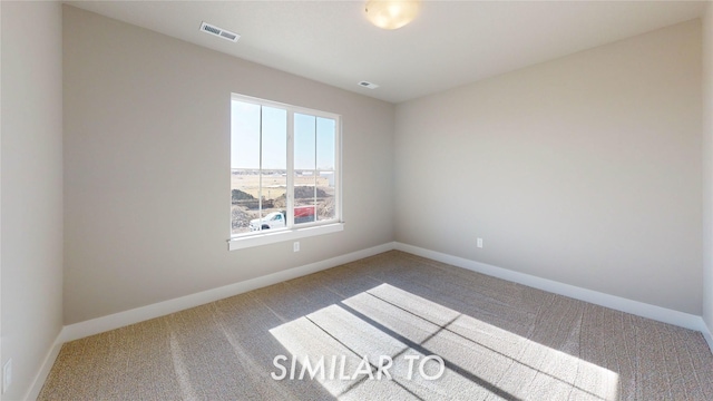 empty room featuring visible vents, carpet flooring, and baseboards