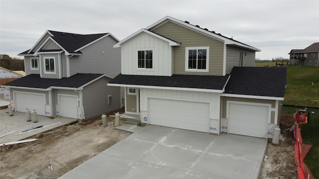 view of front of home featuring board and batten siding, concrete driveway, and a garage