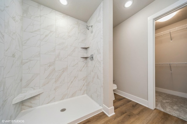 1461 S 91st St, West Des Moines, IA 50266 - full bath featuring tiled shower, wood finished floors, a spacious closet, and recessed lighting