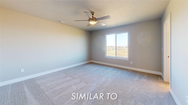 carpeted empty room featuring visible vents, baseboards, and ceiling fan