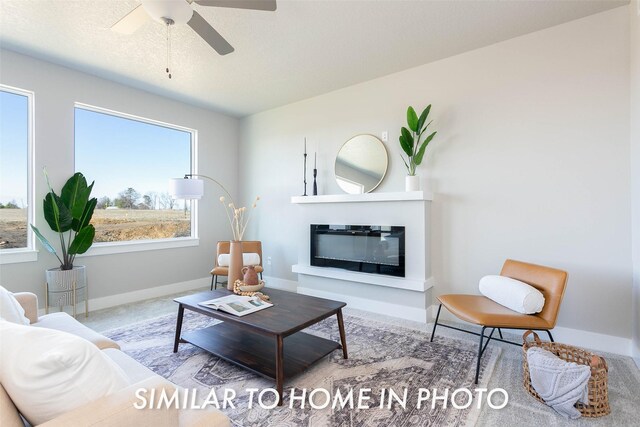 5656 Brook View Ave, Des Moines, IA 50317 - carpeted living area with a glass covered fireplace and ceiling fan