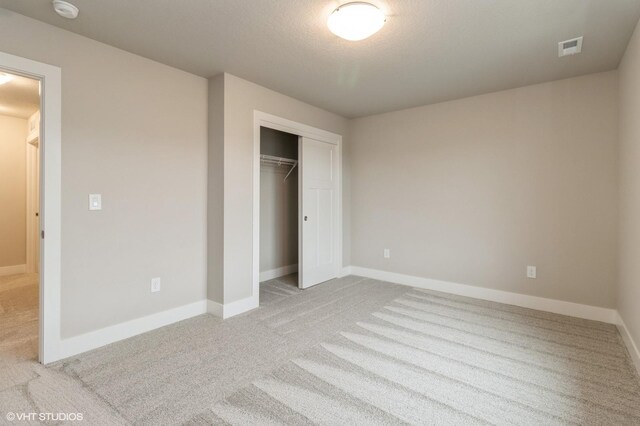 5656 Brook View Ave, Des Moines, IA 50317 - unfurnished bedroom with light colored carpet and a closet