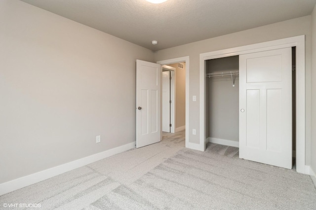 5656 Brook View Ave, Des Moines, IA 50317 - unfurnished bedroom with carpet, a closet, and a textured ceiling