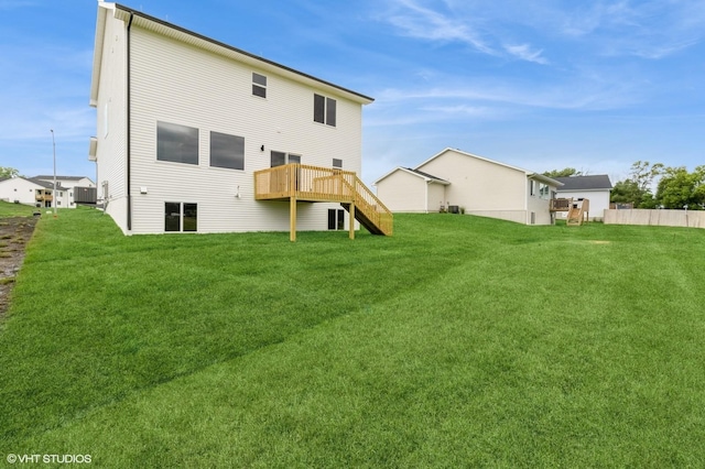 5656 Brook View Ave, Des Moines, IA 50317 - rear view of house with a wooden deck, a lawn, and stairway