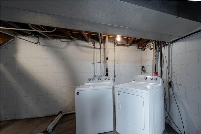 clothes washing area with separate washer and dryer