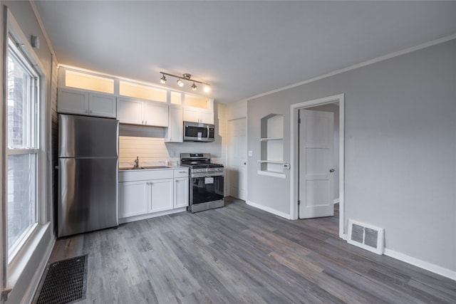 kitchen featuring white cabinetry, a healthy amount of sunlight, stainless steel appliances, and sink