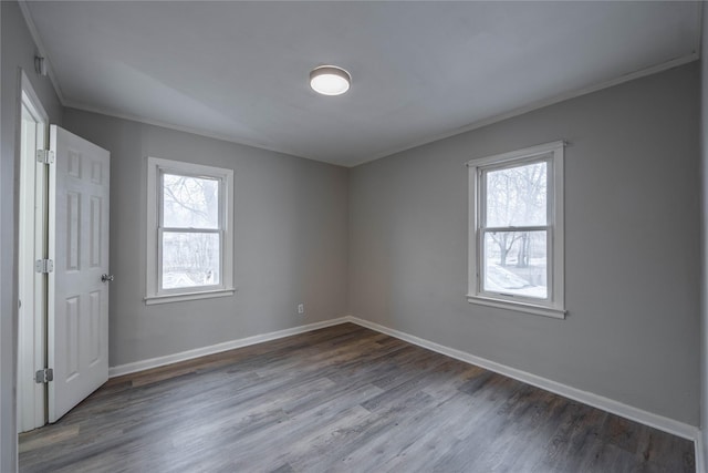 empty room featuring hardwood / wood-style flooring and ornamental molding