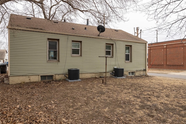 rear view of house with central air condition unit