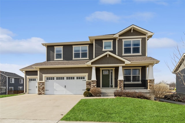 craftsman-style home featuring a front yard, a garage, and a porch