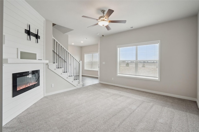 unfurnished living room with carpet flooring and ceiling fan