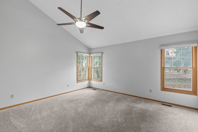 carpeted spare room with high vaulted ceiling, a healthy amount of sunlight, and ceiling fan