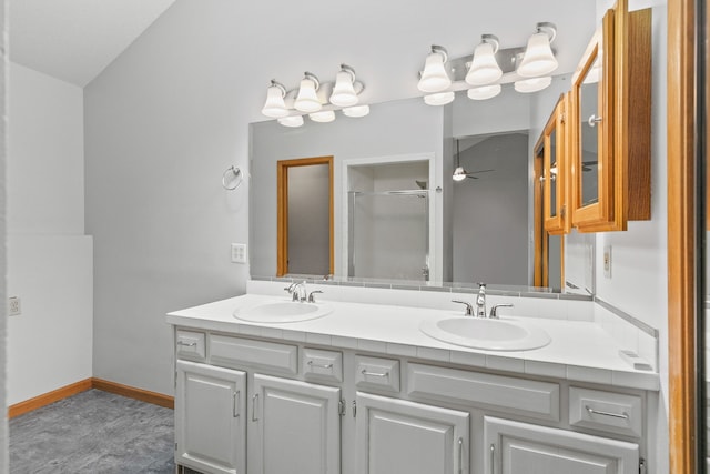 bathroom featuring ceiling fan, vanity, and a shower with shower door